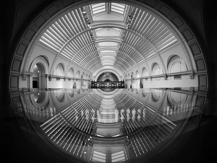 The reflection of the main hall in a glass case at the Victoria & Albert Museum, London shot by Thomas Knowles / ©archphotoawards.com